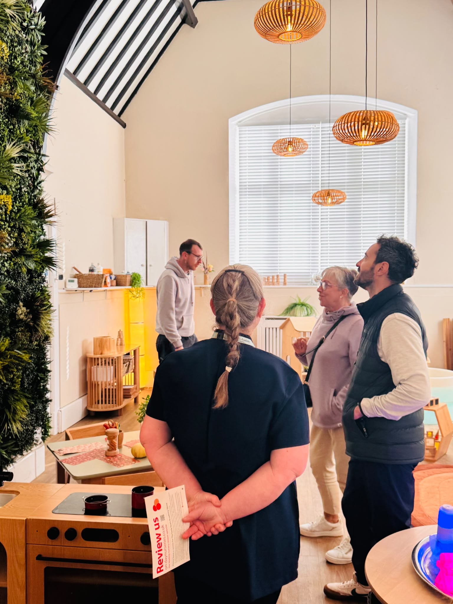 Visitors looking around an indoor learning space at the nursery open day